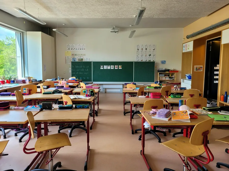 School classroom with desks and a chalkboard