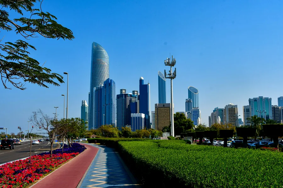 Abu Dhabi Corniche with flower beds and the city skyline