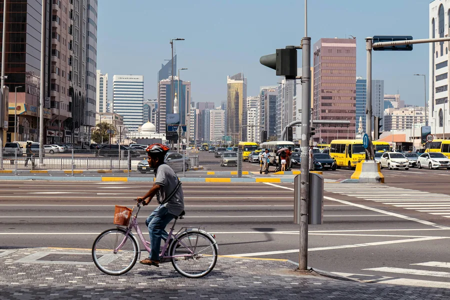 Cyclist crossing a city junction in Abu Dhabi
