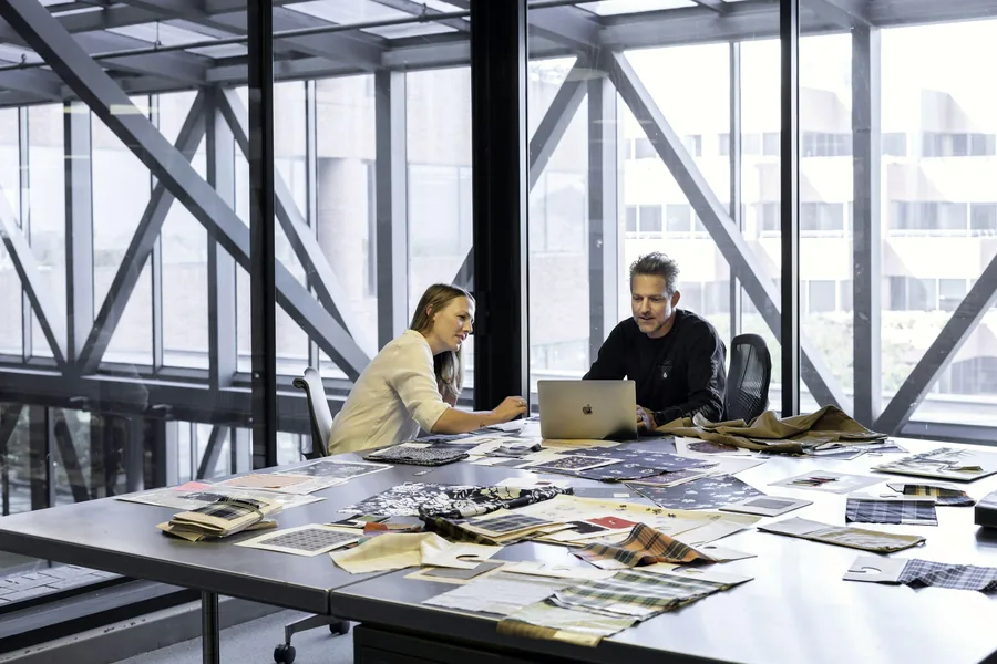 Engineers reviewing drawings at a studio table